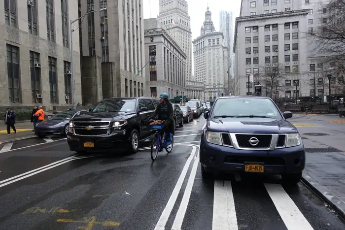 A cyclist navigates traffic on Centre Street in Lower Manhattan